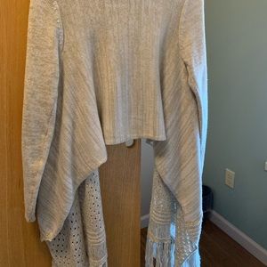 Woman’s small beige and white sweater